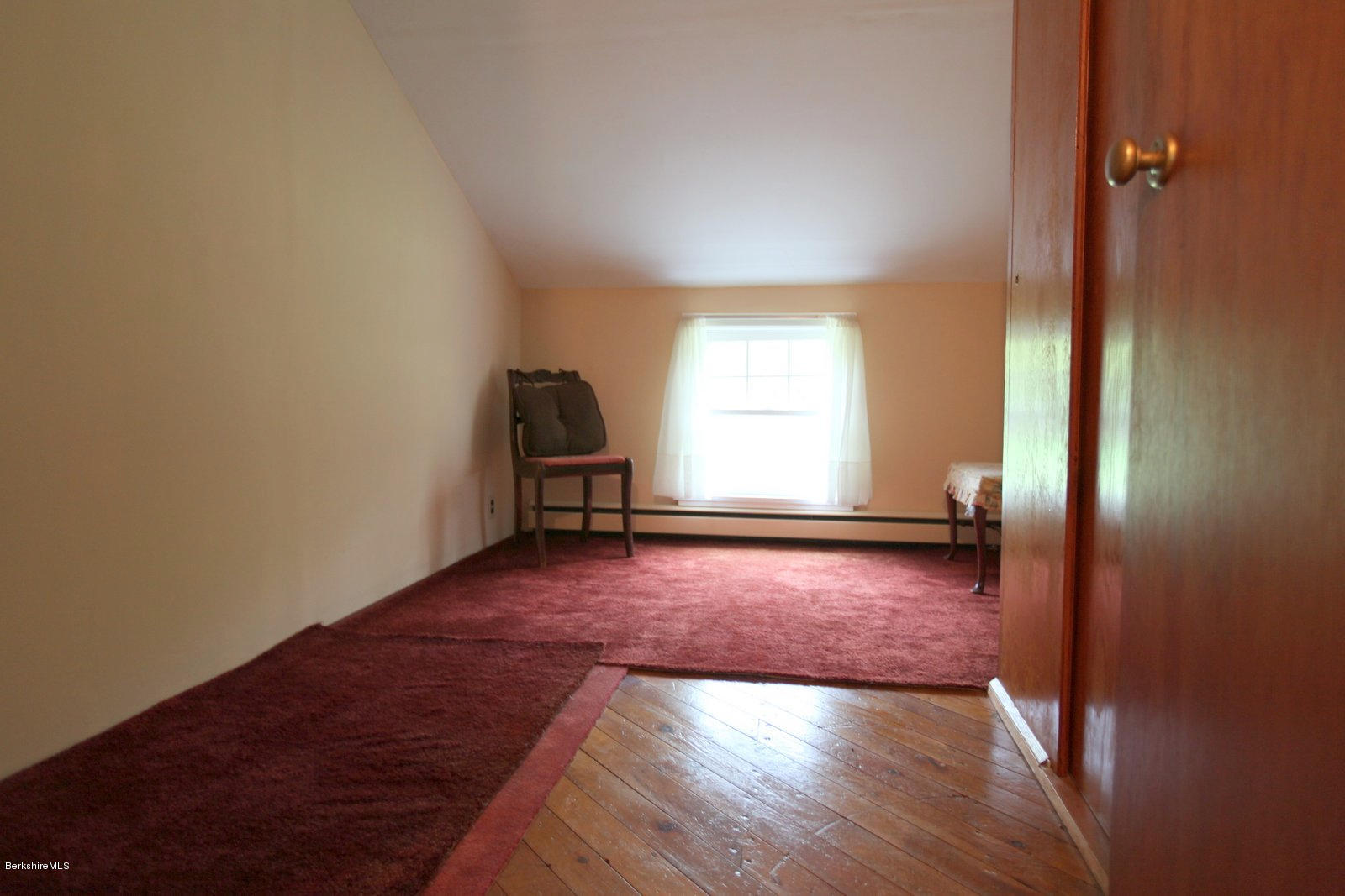 136 Tyringham Road Monterey, MA 01245 - Photo 22 of 27 an empty room with wooden floor and windows