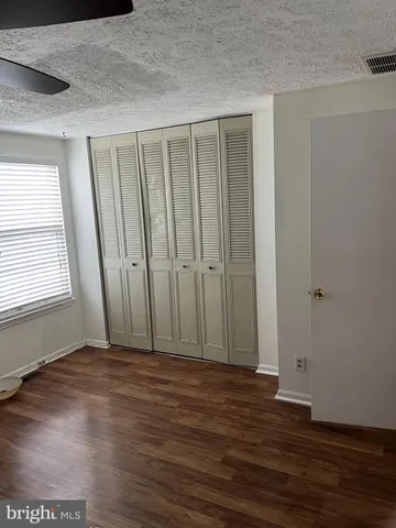 a view of wooden floor and windows in a room