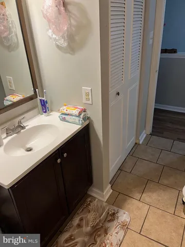 a bathroom with a sink vanity and a mirror