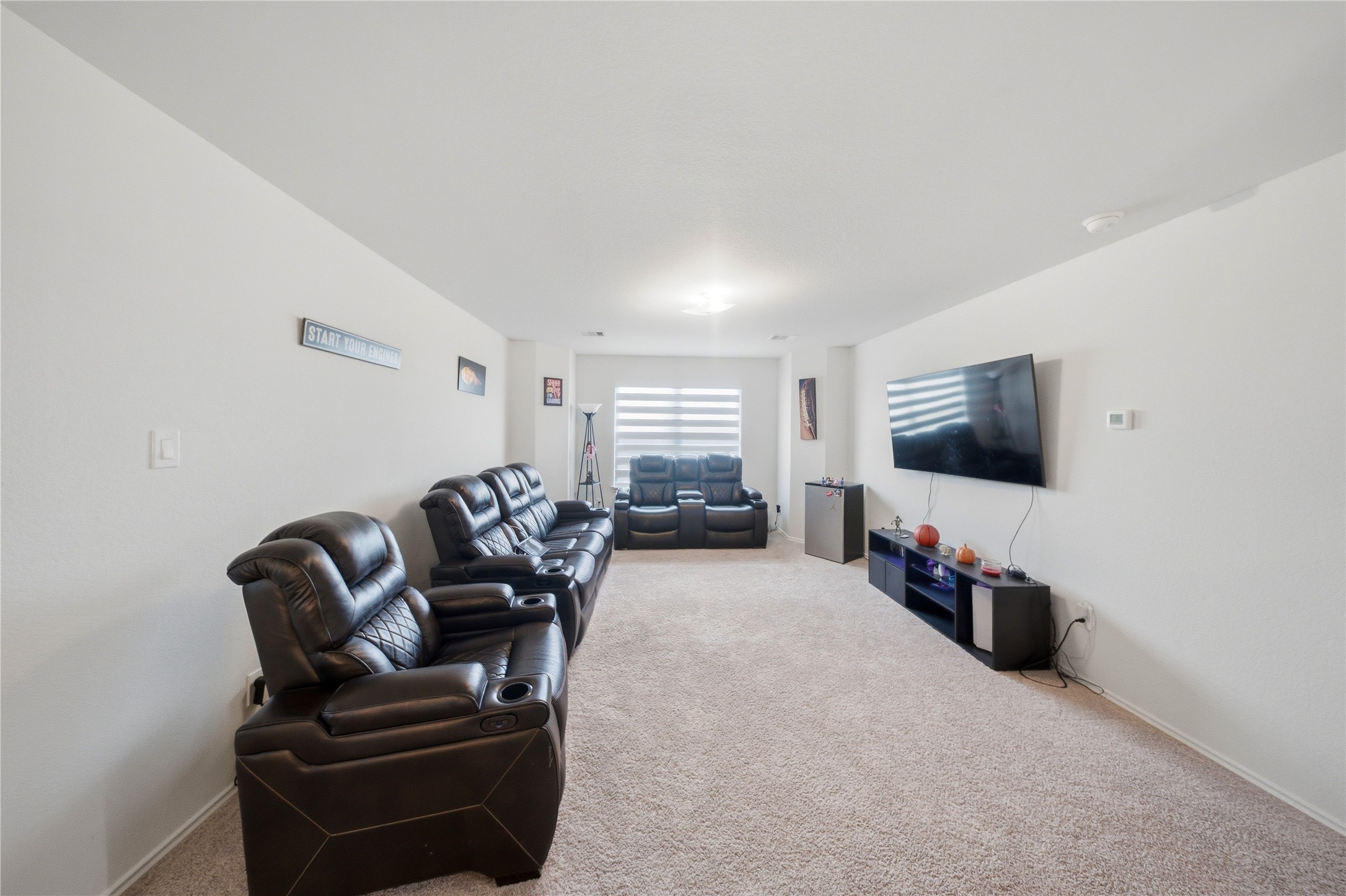 1622 Homewood Point Lane Rosharon, TX 77583 - Photo 20 of 41 a living room with furniture a flat screen tv and gym equipment