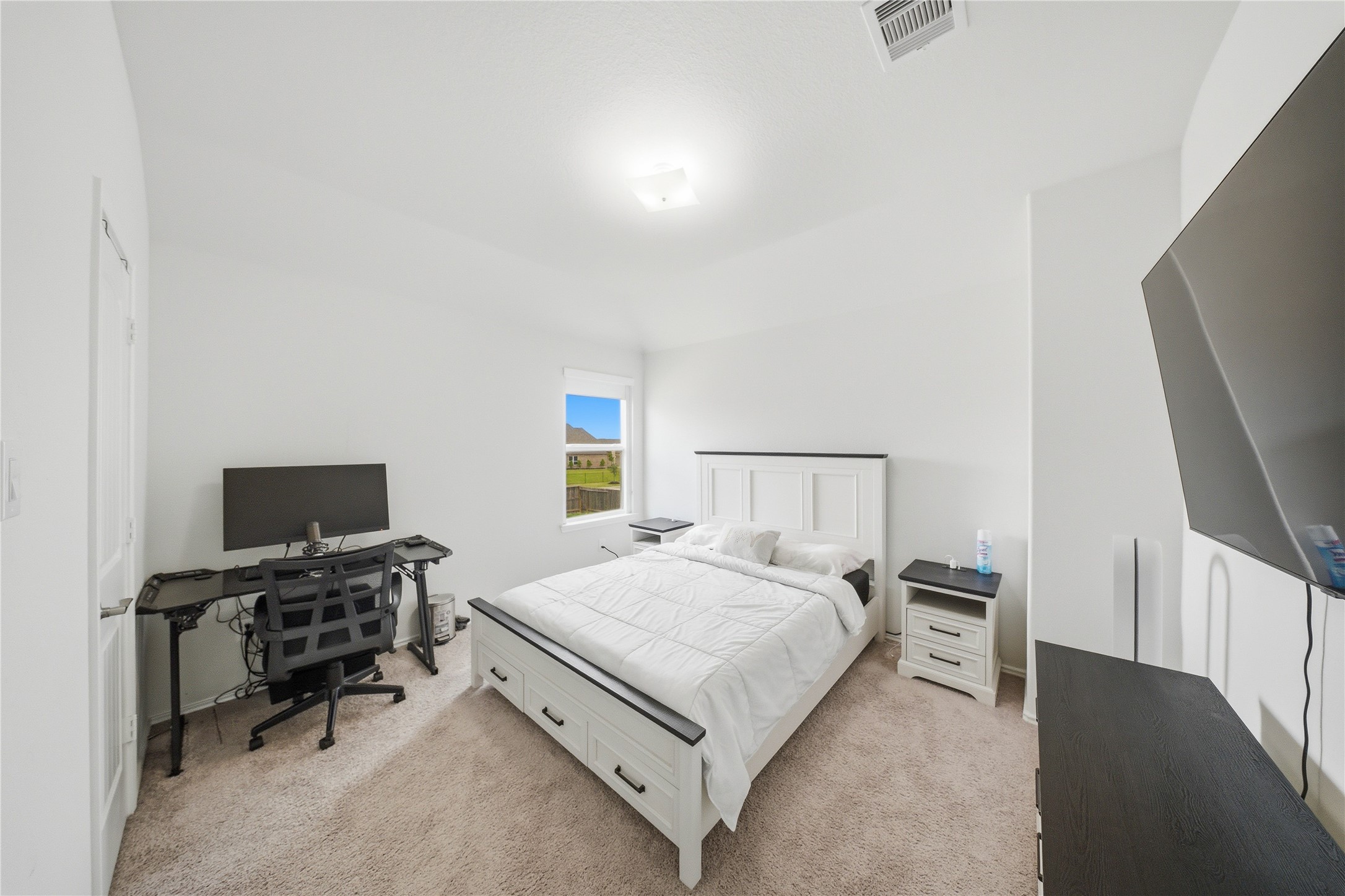 1622 Homewood Point Lane Rosharon, TX 77583 - Photo 25 of 41 a bedroom with a bed and a flat screen tv
