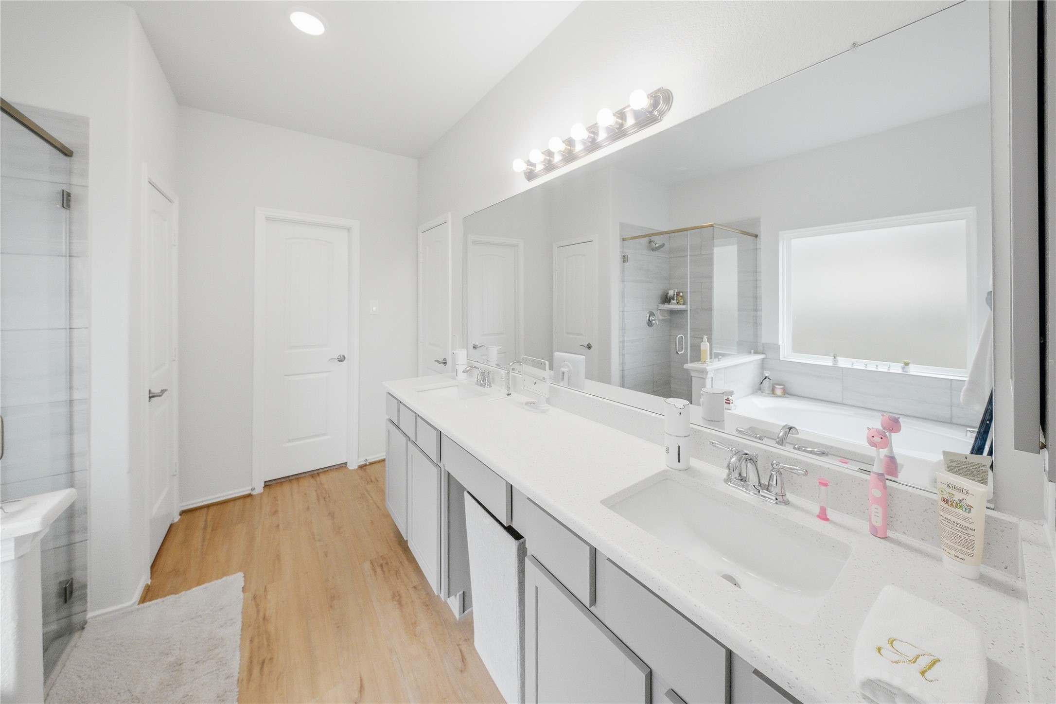 1622 Homewood Point Lane Rosharon, TX 77583 - Photo 26 of 41 a spacious bathroom with a double vanity sink and a mirror