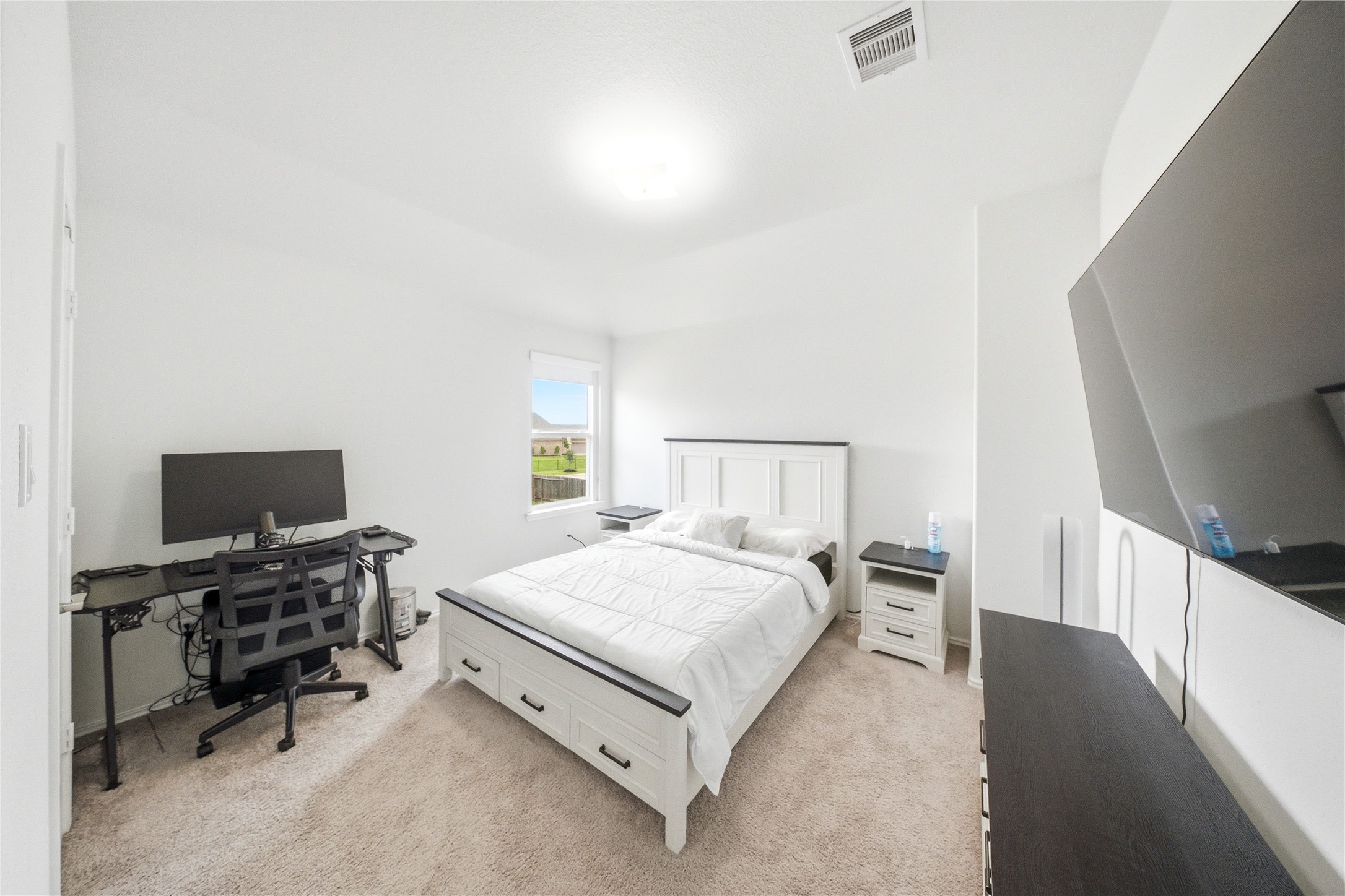 1622 Homewood Point Lane Rosharon, TX 77583 - Photo 36 of 41 a bedroom with a bed and a flat screen tv