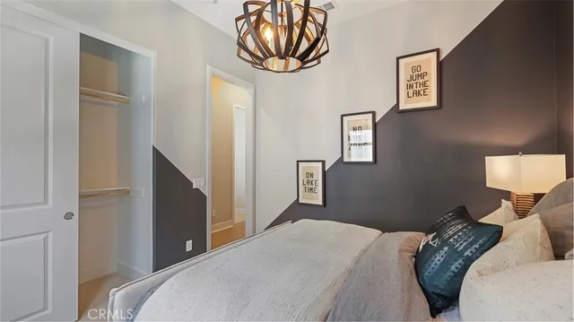 a bedroom with bed and a mirror