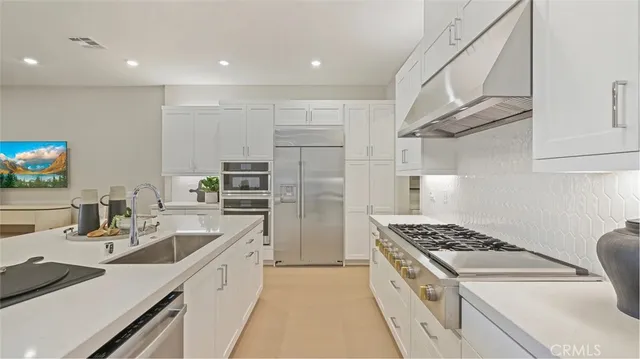 a kitchen that has a sink and a stove