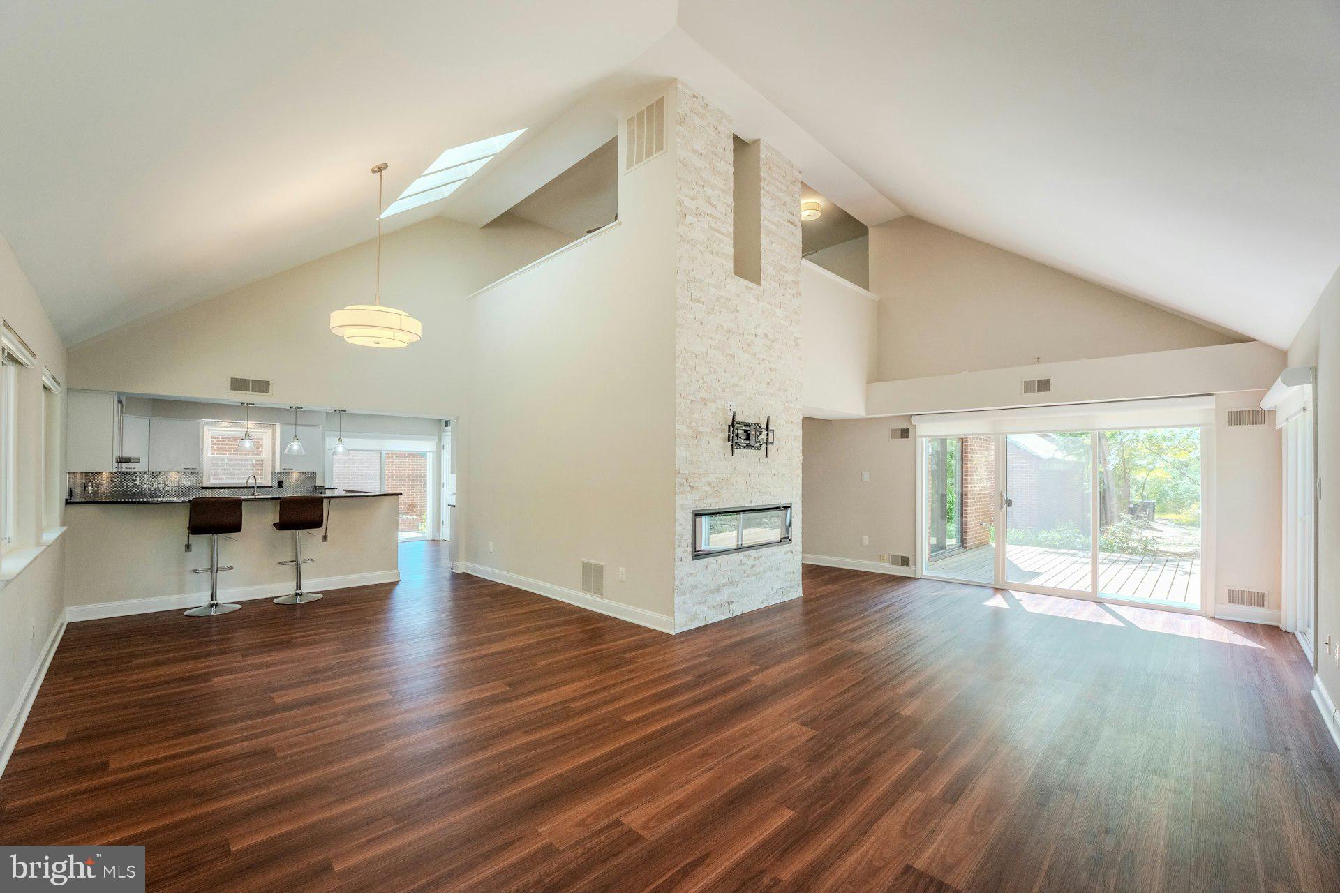 11310 Harborside Cluster Reston, VA 20191 - Photo 21 of 71 Dining room and family room with soaring ceilings.