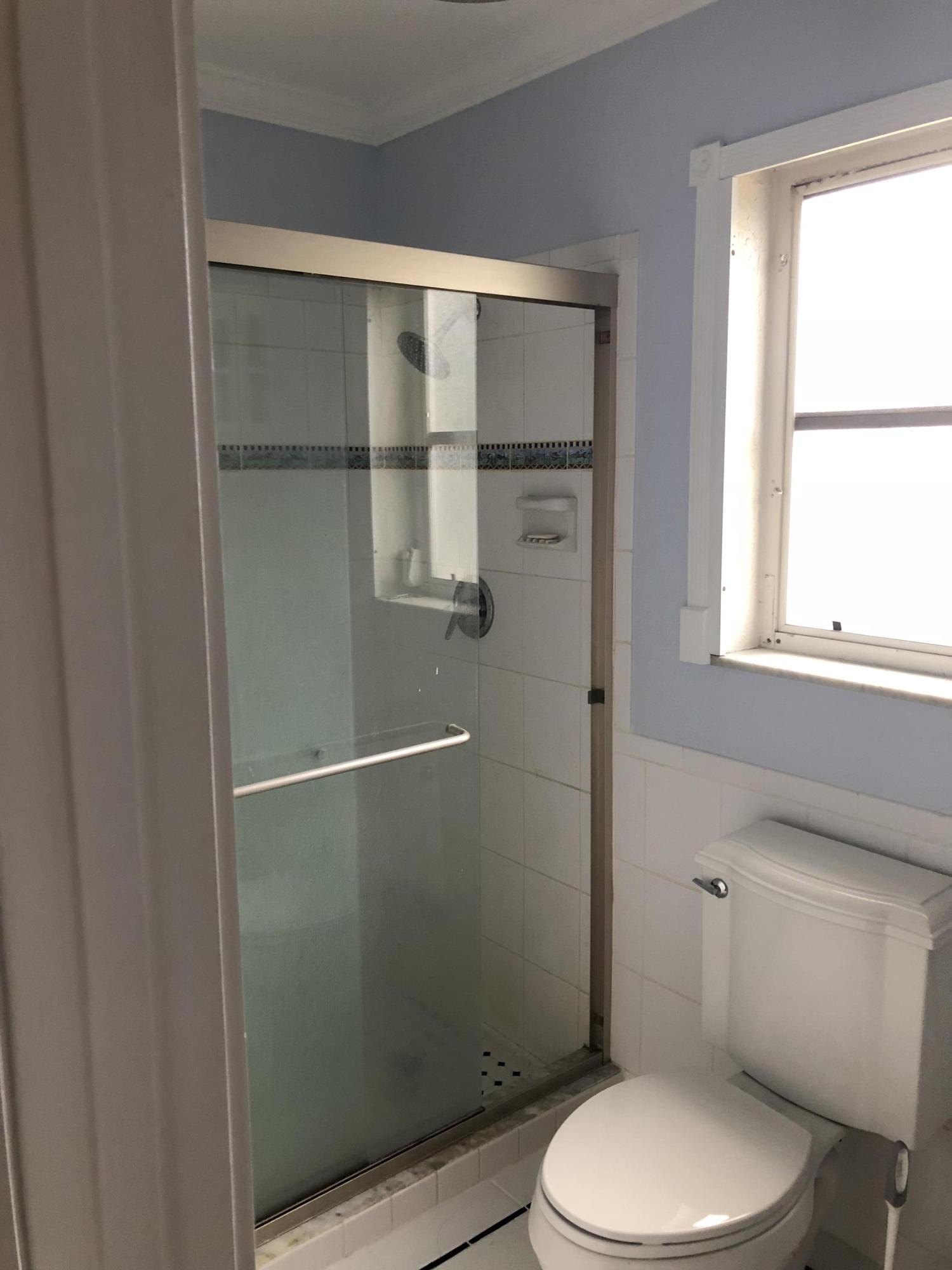 1229 Northwest Fork Road Stuart, FL 34994 - Photo 20 of 25 a white toilet sitting next to a window