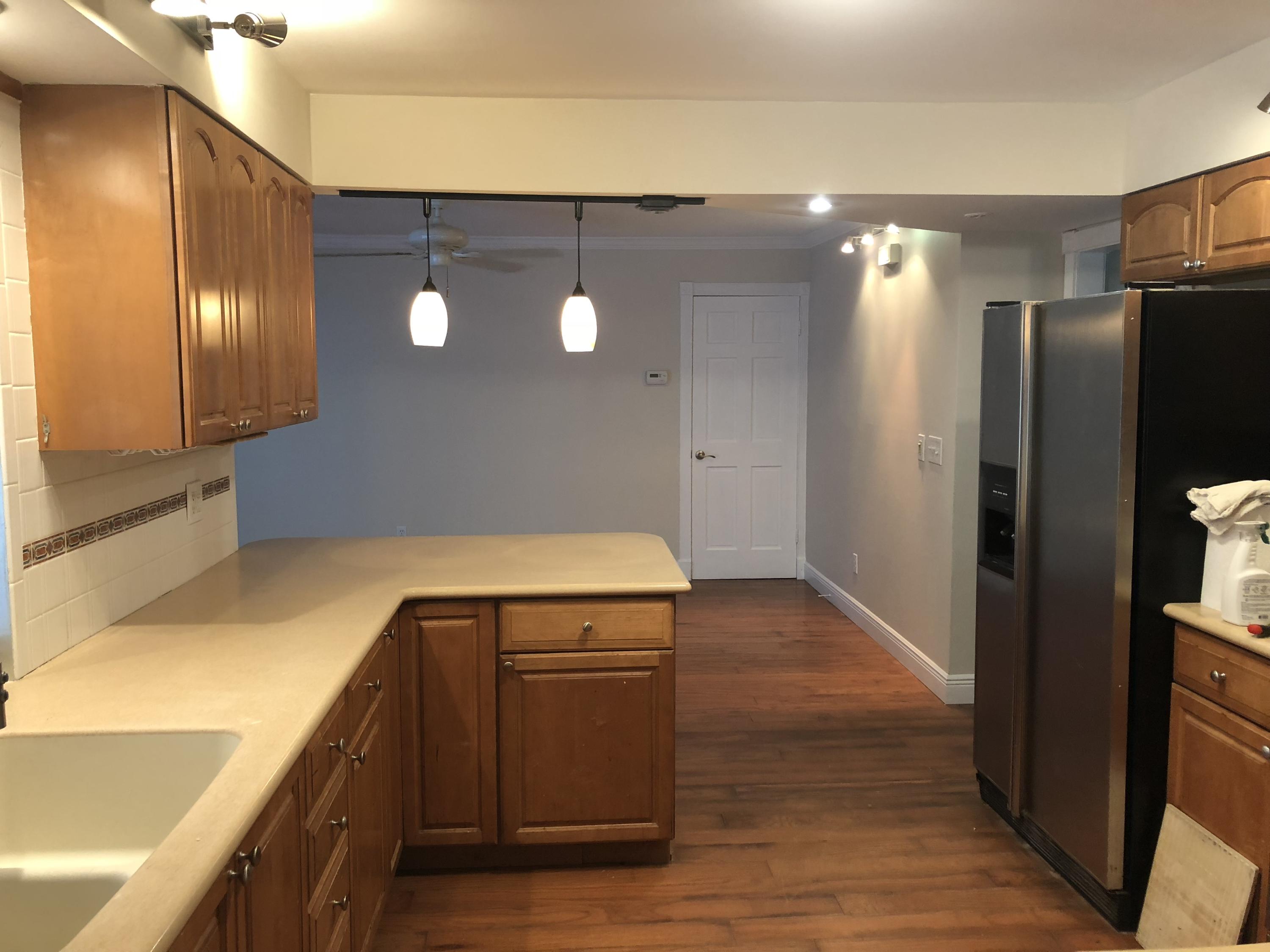 1229 Northwest Fork Road Stuart, FL 34994 - Photo 7 of 25 a kitchen with a refrigerator and a sink