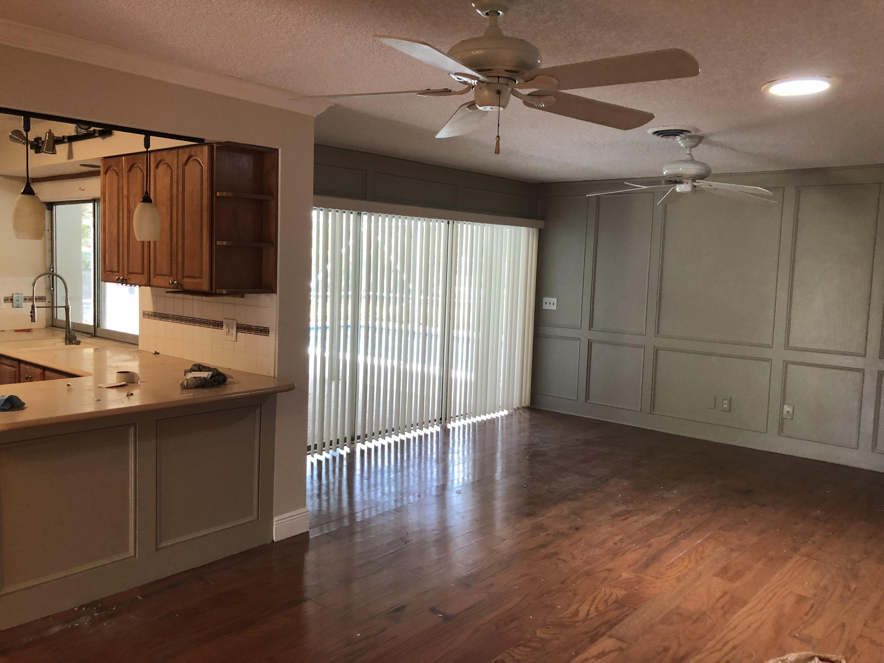 1229 Northwest Fork Road Stuart, FL 34994 - Photo 8 of 25 a spacious bathroom with a glass shower door and a wooden floor