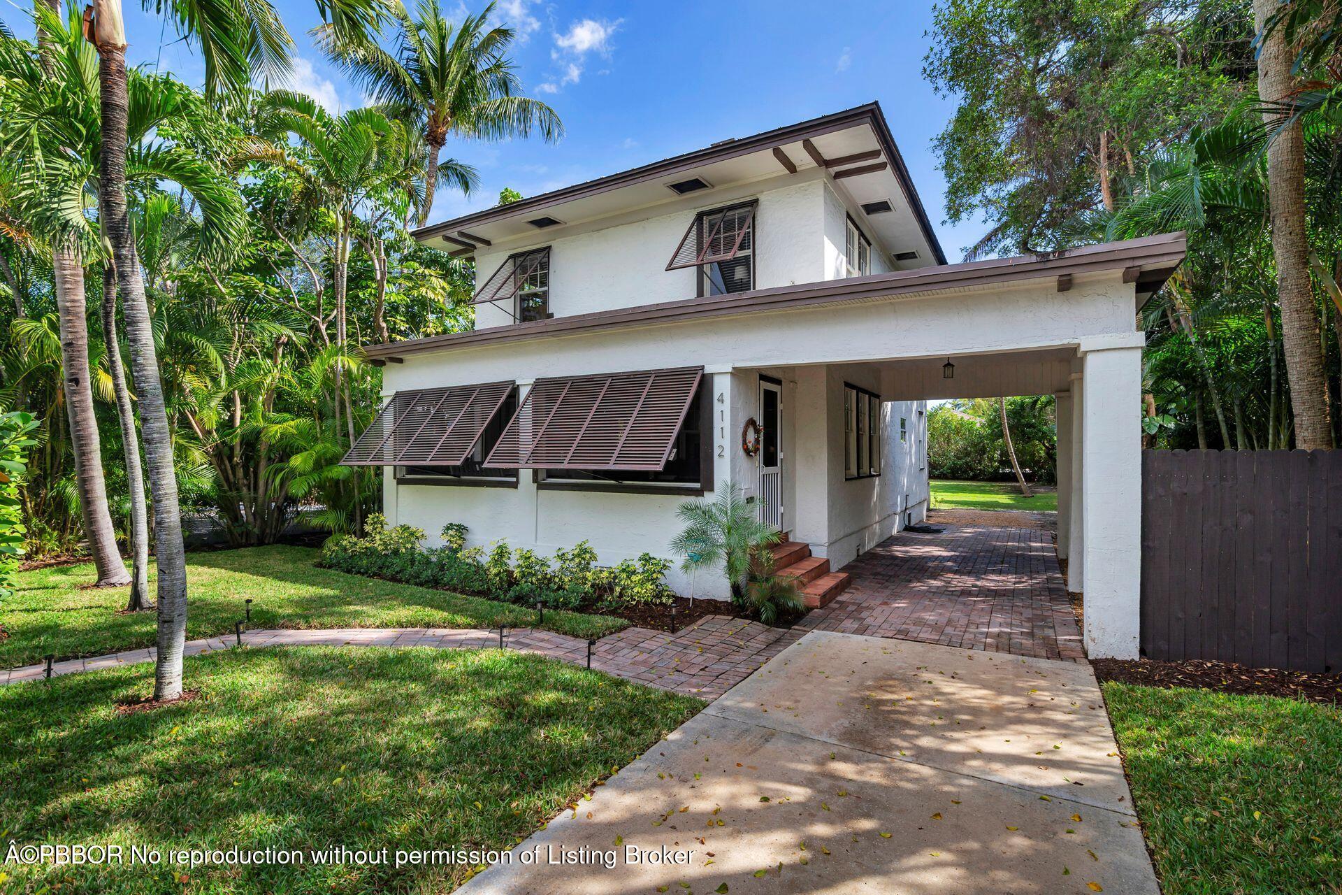 4112 Washington Road West Palm Beach, FL 33405 - Photo 1 of 41 a front view of a house with a garden