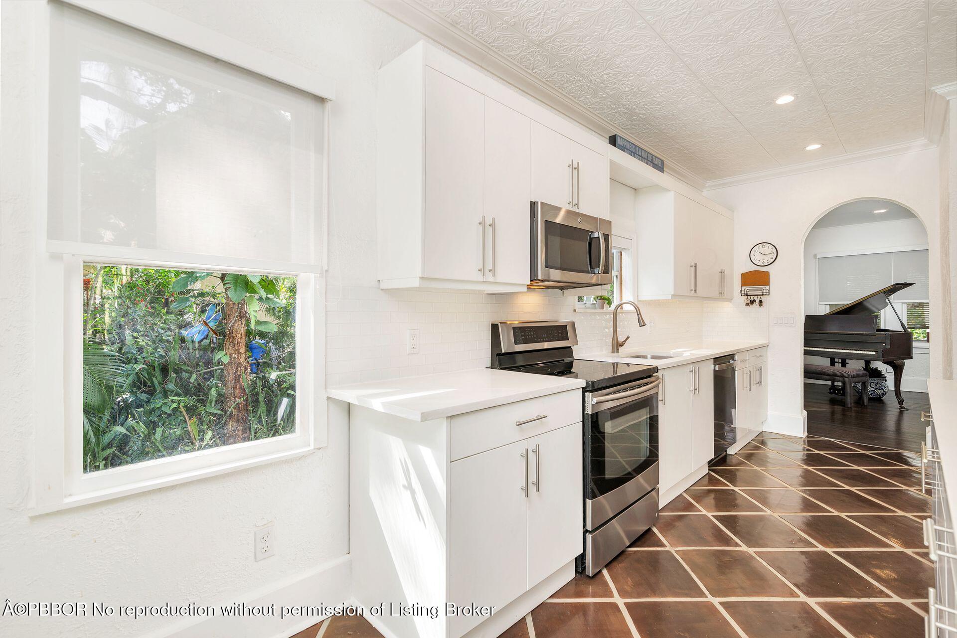 4112 Washington Road West Palm Beach, FL 33405 - Photo 11 of 41 a kitchen with a sink window and stainless steel appliances