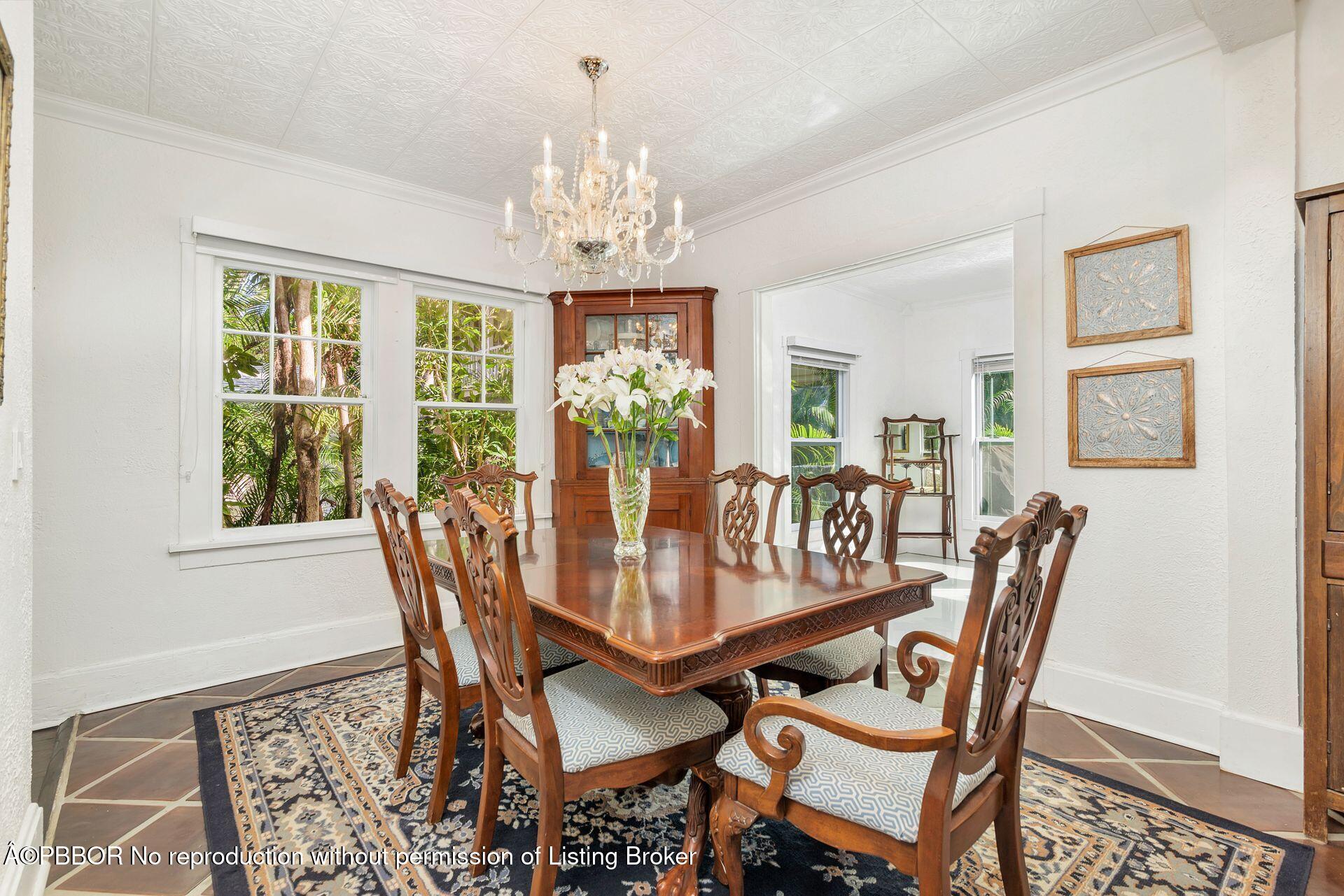 4112 Washington Road West Palm Beach, FL 33405 - Photo 14 of 41 a view of a dining room with furniture a chandelier and wooden floor
