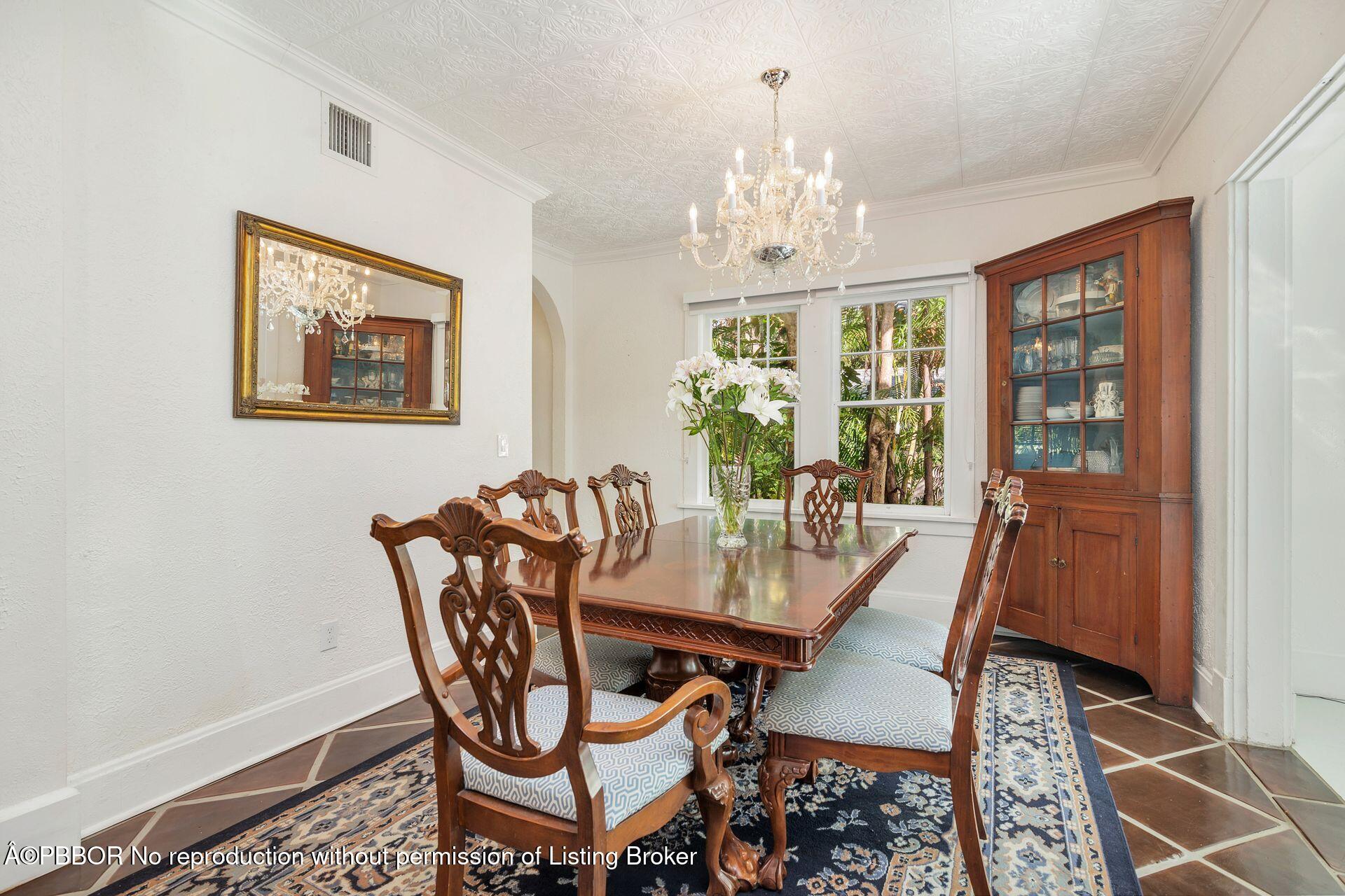 4112 Washington Road West Palm Beach, FL 33405 - Photo 15 of 41 a view of a dining room with furniture a chandelier and wooden floor