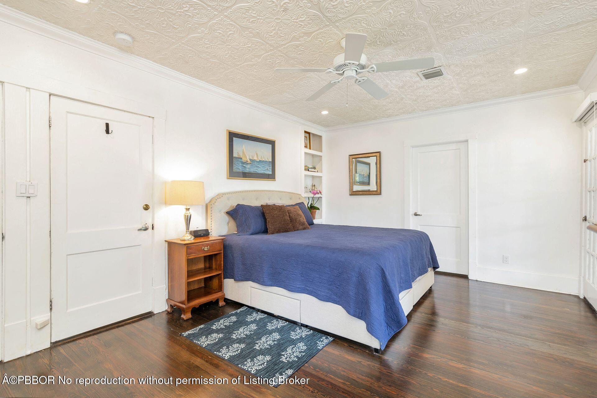4112 Washington Road West Palm Beach, FL 33405 - Photo 17 of 41 a spacious bedroom with a bed and a chandelier