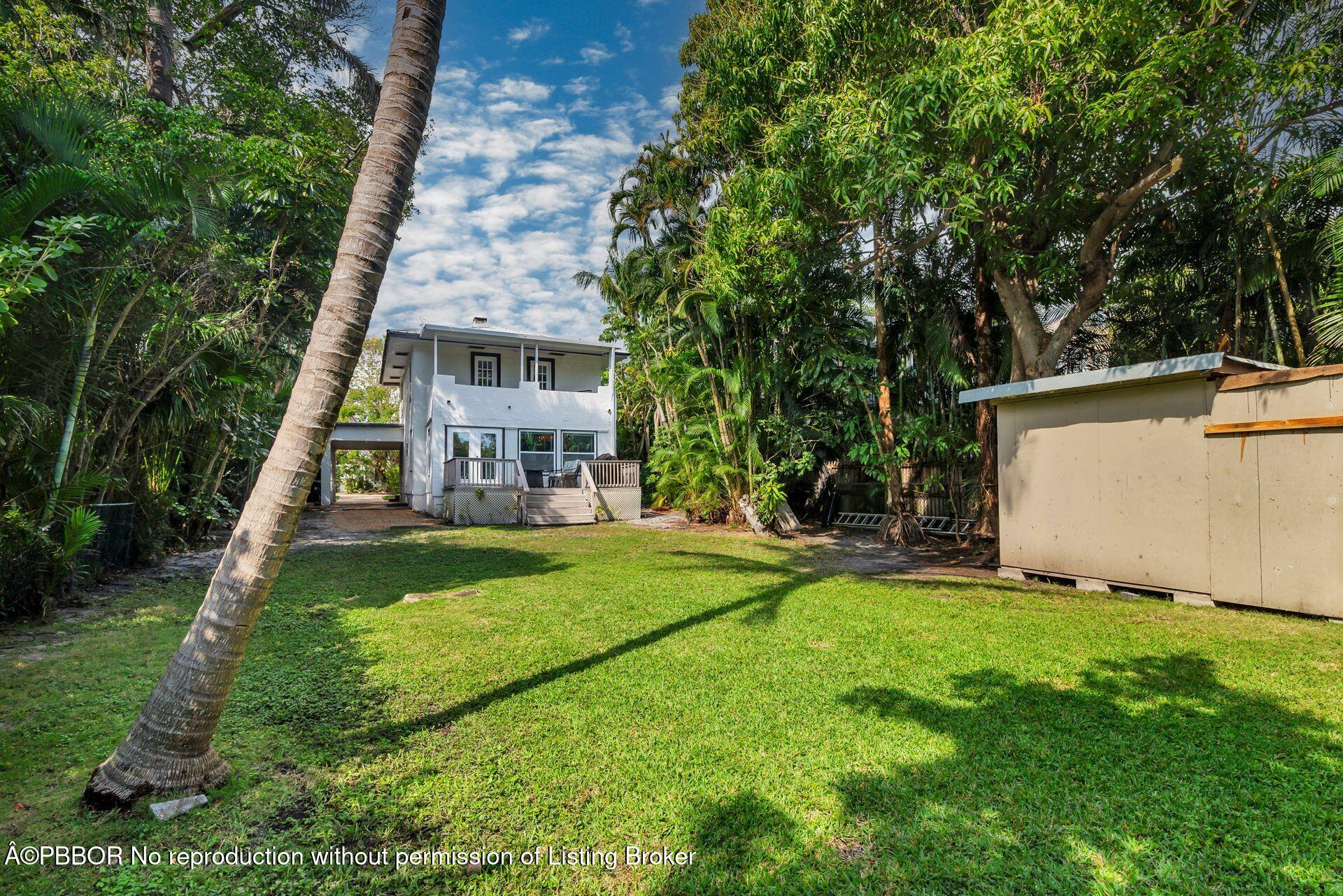 4112 Washington Road West Palm Beach, FL 33405 - Photo 30 of 41 a view of a house with backyard and a tree