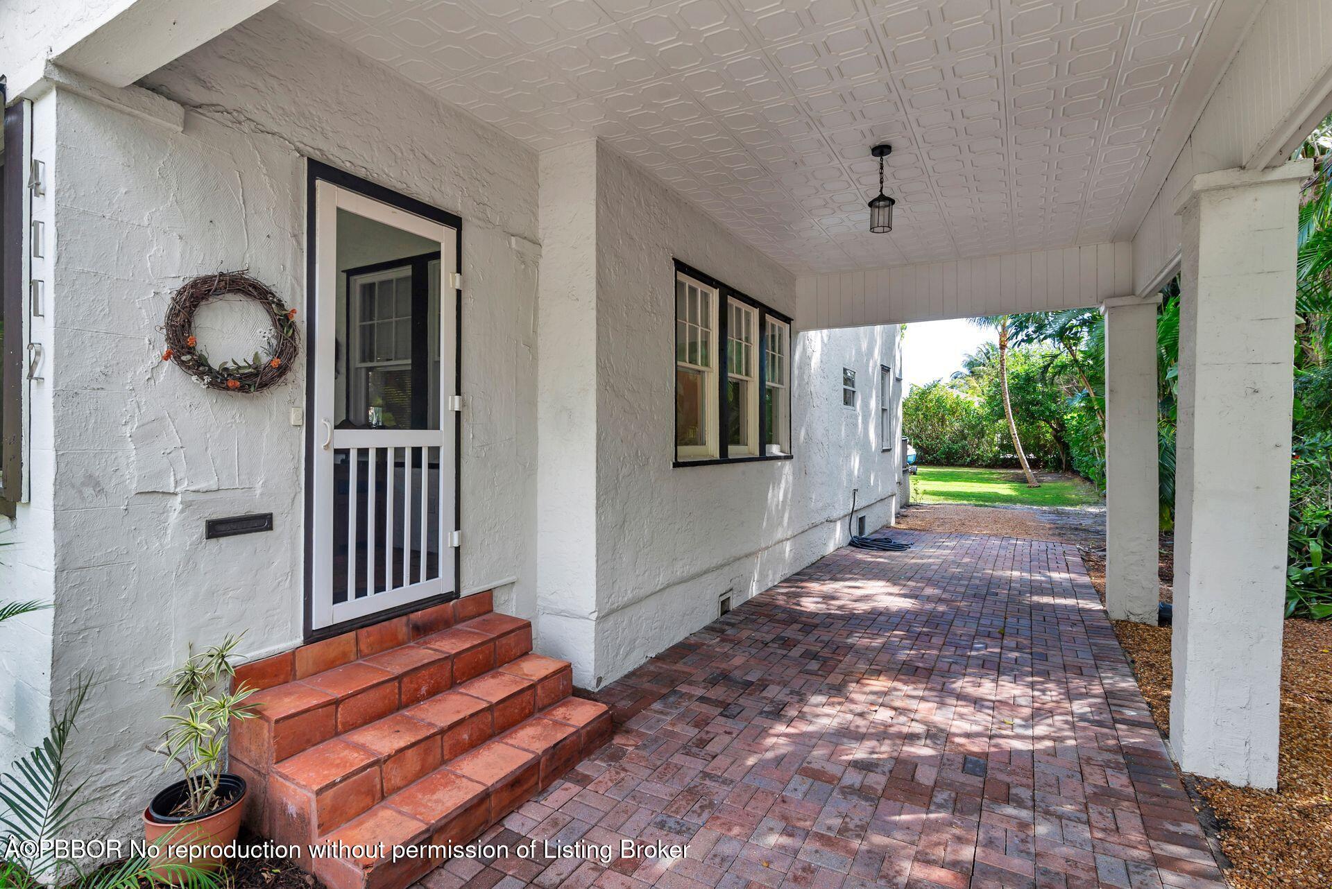4112 Washington Road West Palm Beach, FL 33405 - Photo 3 of 41 a view of a porch with wooden floor and front door
