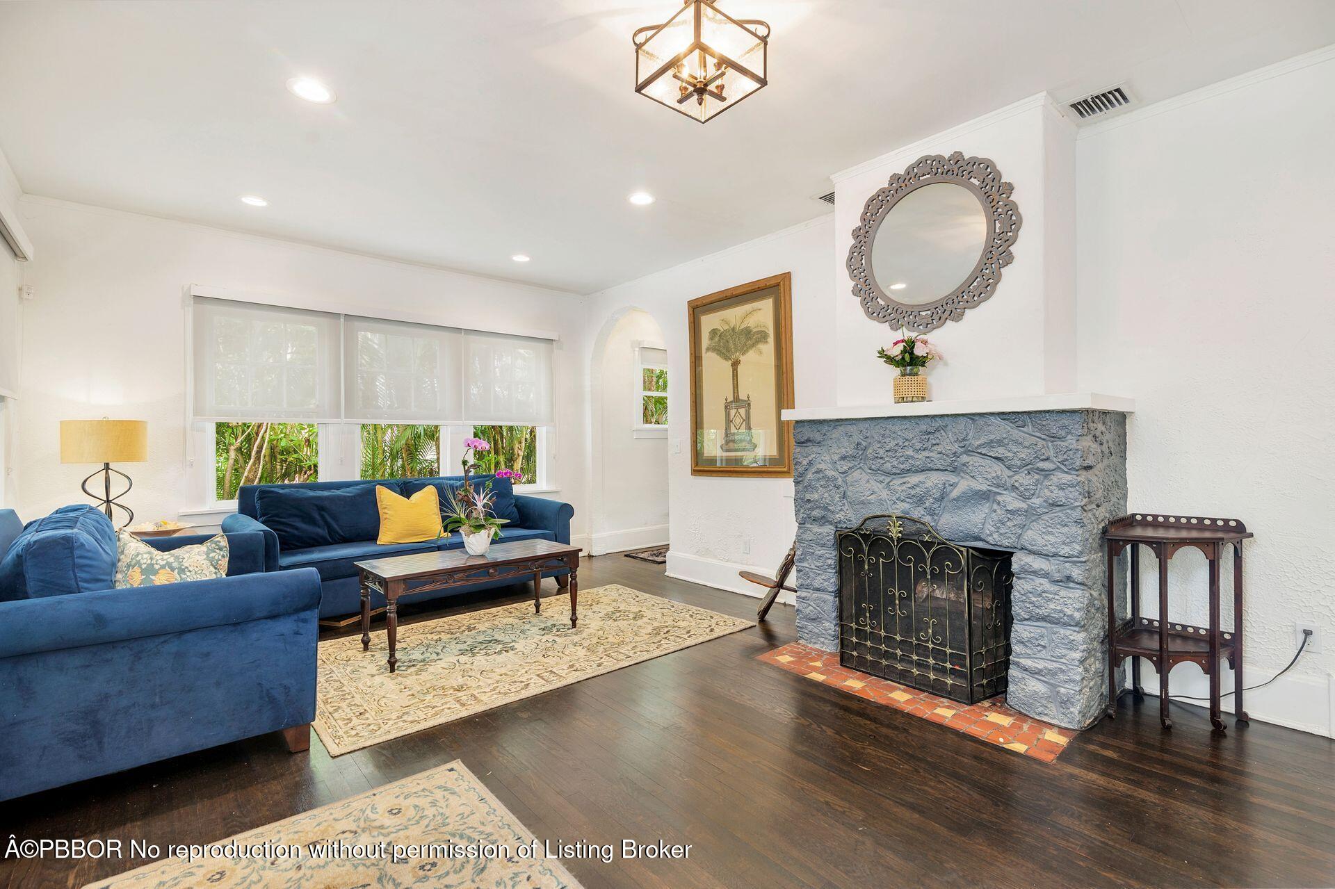4112 Washington Road West Palm Beach, FL 33405 - Photo 8 of 41 a living room with furniture a fireplace a rug and a window