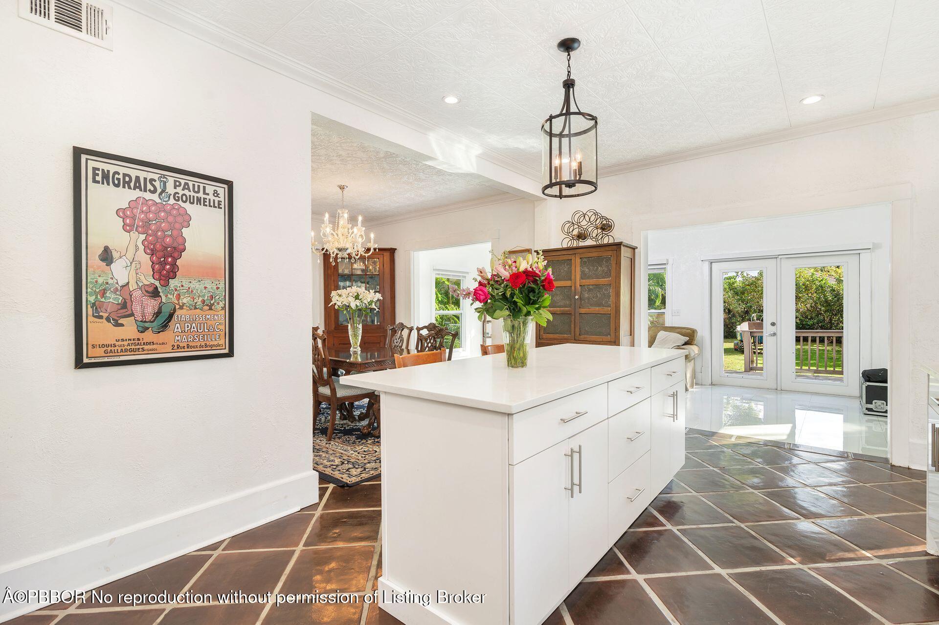 4112 Washington Road West Palm Beach, FL 33405 - Photo 10 of 41 a kitchen that has a lot of cabinets stainless steel appliances and a chandelier