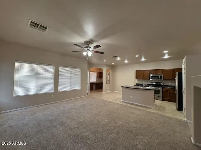 a view of kitchen with refrigerator and window