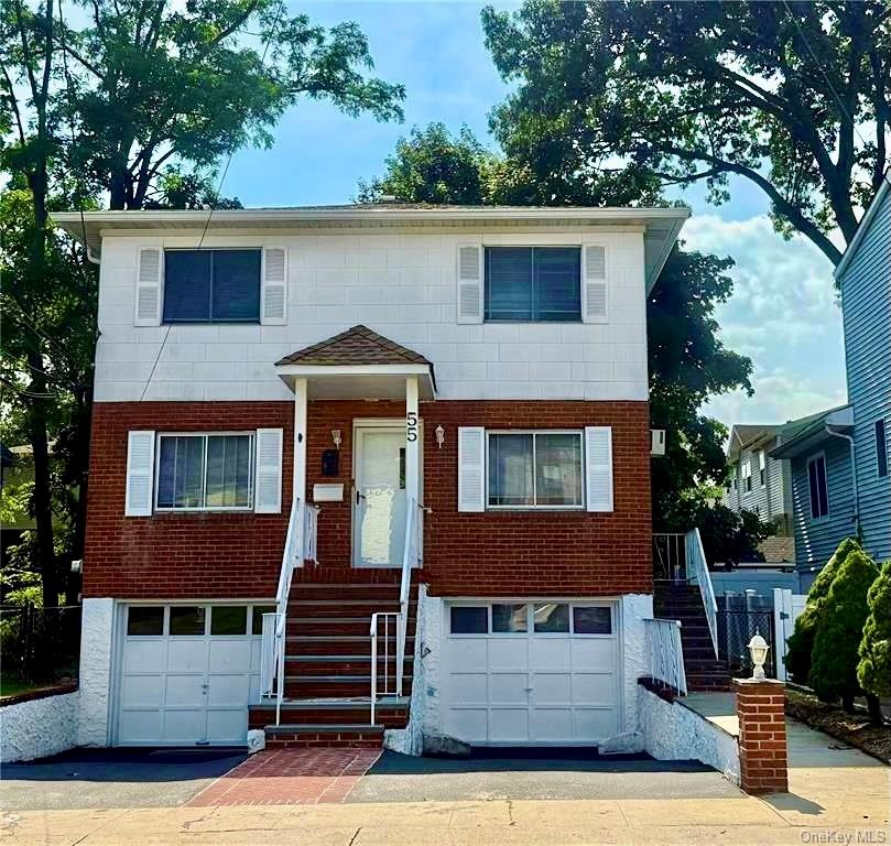 55 Hickory Road, Unit 1 Port Washington, NY 11050 - Photo 1 of 1 a front view of a house with garage