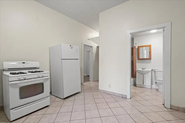 a kitchen with a stove top oven and cabinets