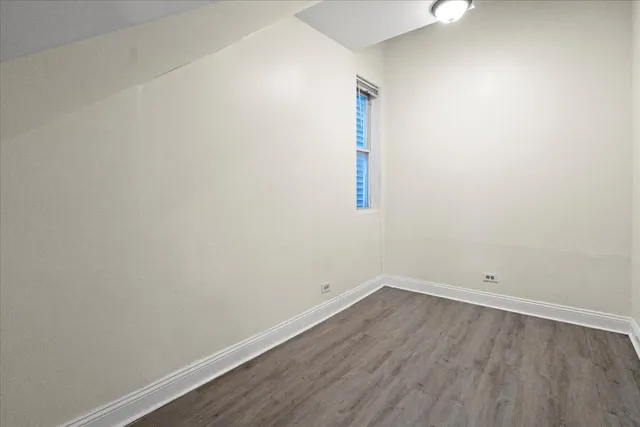 a view of a room with wooden floor and white walls