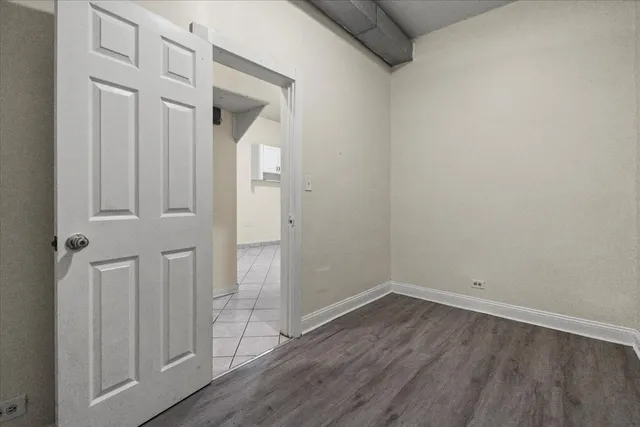 wooden floor and white door
