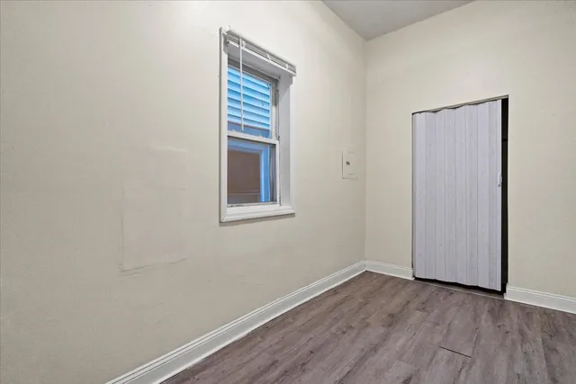 a view of a room with wooden floor and windows