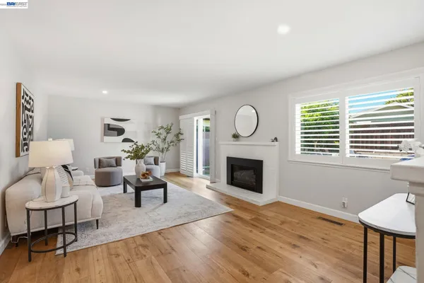 a living room with furniture a fireplace and a table