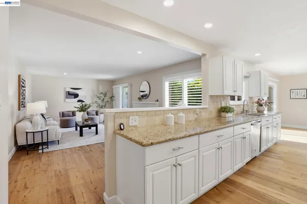 a kitchen with center island table and chairs