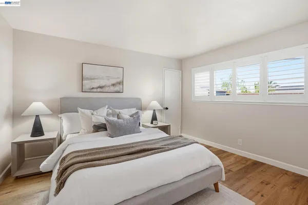 a bedroom with bed and a window