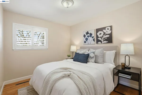a bedroom with a bed and a lamp