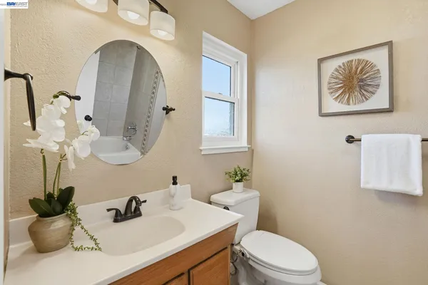 a bathroom with a toilet sink and mirror