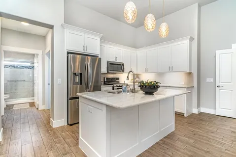 a kitchen with stainless steel appliances a sink stove and refrigerator