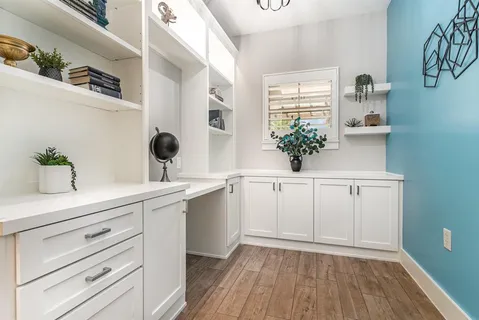 a view of cabinets a wooden floor and a window
