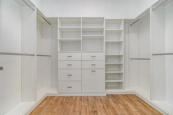a view of walk in closet with empty racks