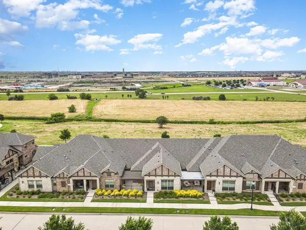 an aerial view of residential houses with outdoor space and ocean view