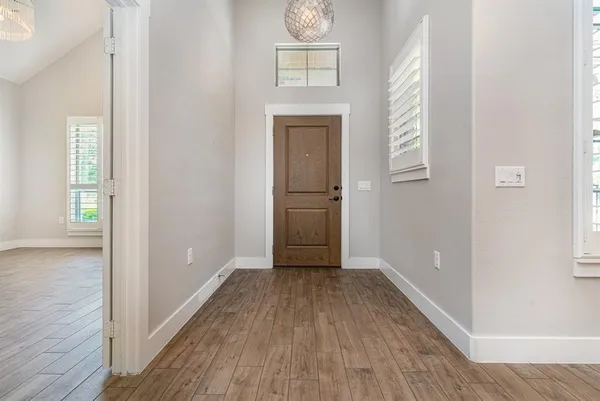 a view of hallway with wooden floor