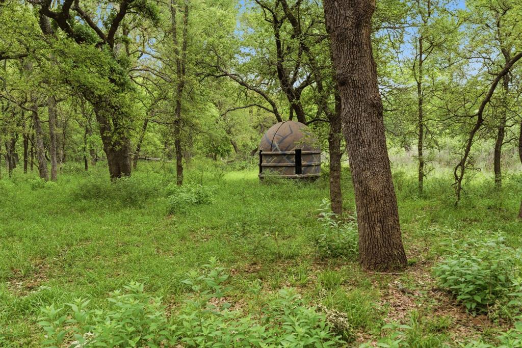Tbd Old Post Oak Road Bowie, TX 76230 - Photo 21 of 40 a backyard of a house with table and chairs