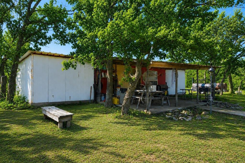 Tbd Old Post Oak Road Bowie, TX 76230 - Photo 37 of 40 a backyard of a house with yard and outdoor seating