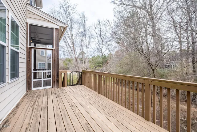 a balcony with wooden floor and fence