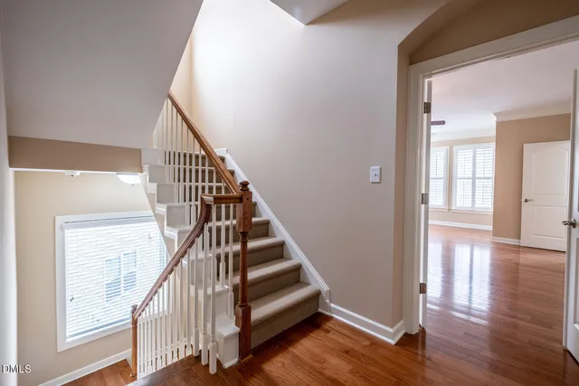 a view of entryway and hall with wooden floor