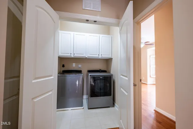 a kitchen with granite countertop white cabinets and stainless steel appliances