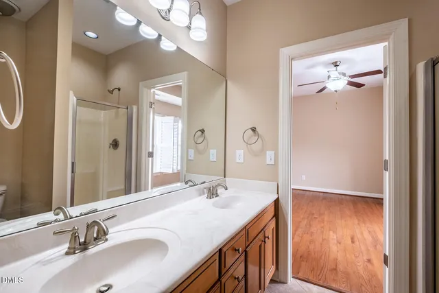 a bathroom with a double vanity sink and a mirror