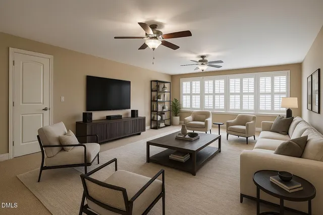 a living room with furniture a ceiling fan and a flat screen tv