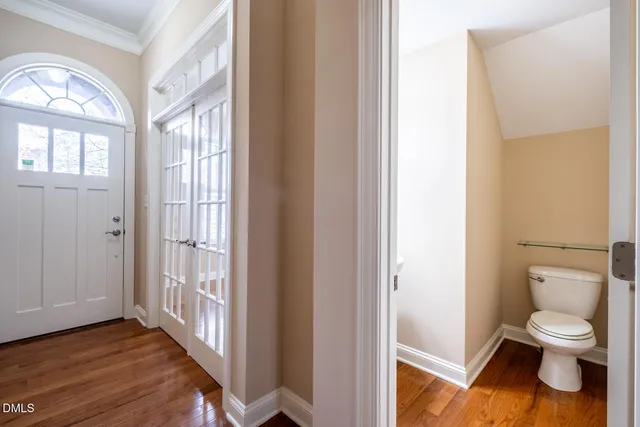 a bathroom with a toilet a sink and a window
