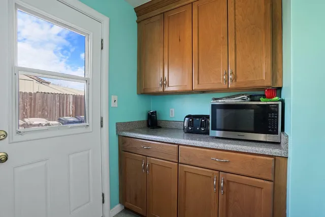 a kitchen with stainless steel appliances granite countertop a sink stove and cabinets