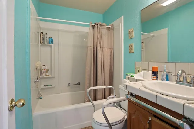 a bathroom with a sink toilet and shower
