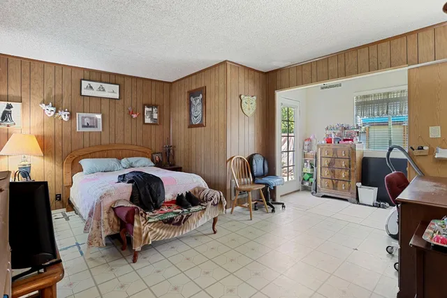 a bedroom with furniture and a flat screen tv