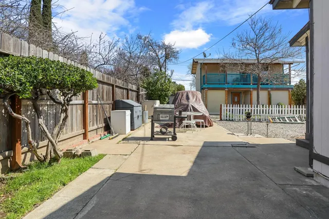 a view of a patio with a table and chairs